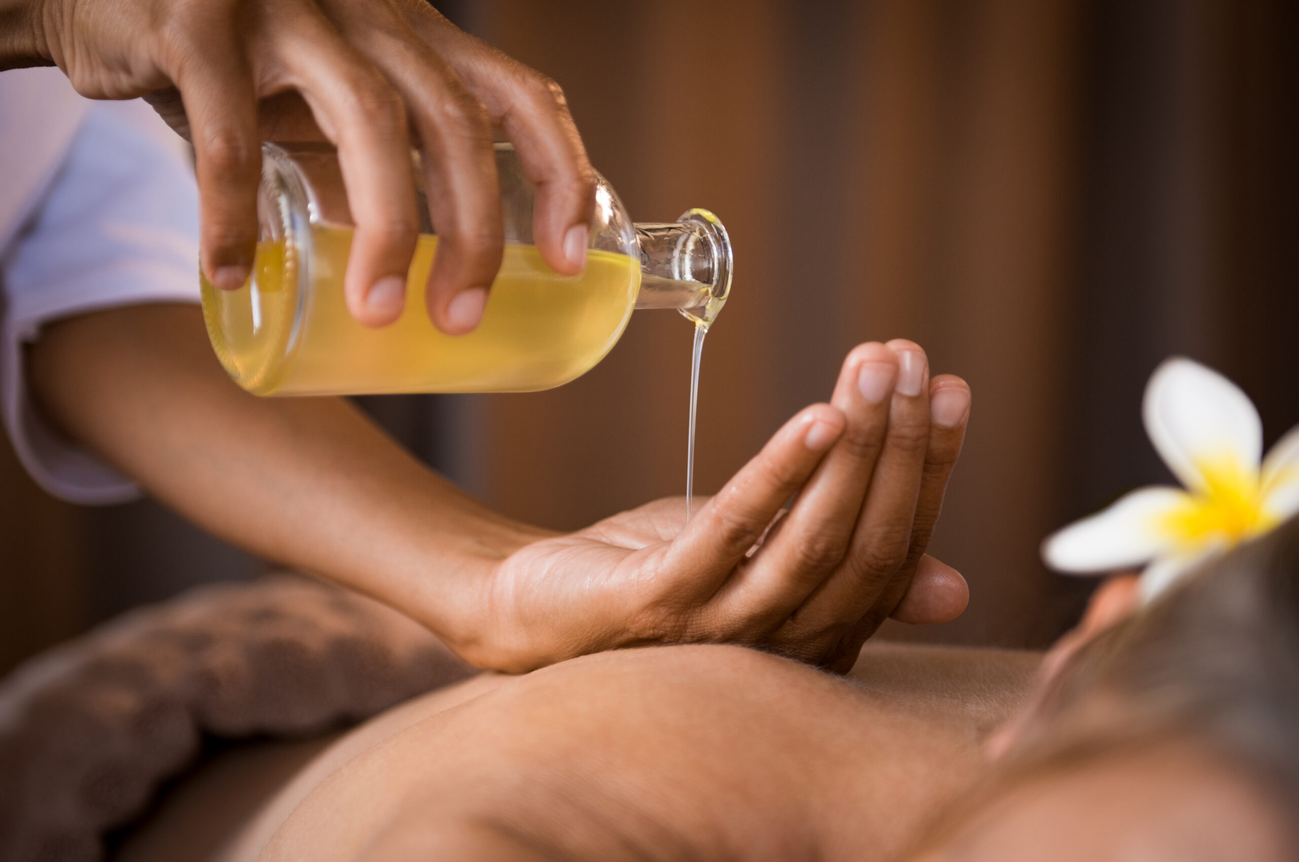 Therapist Pouring Massage Oil Spa Scaled 1